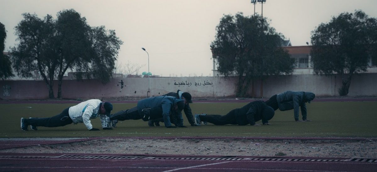 a group of people on a track doing push ups