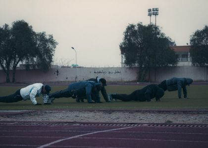 a group of people on a track doing push ups
